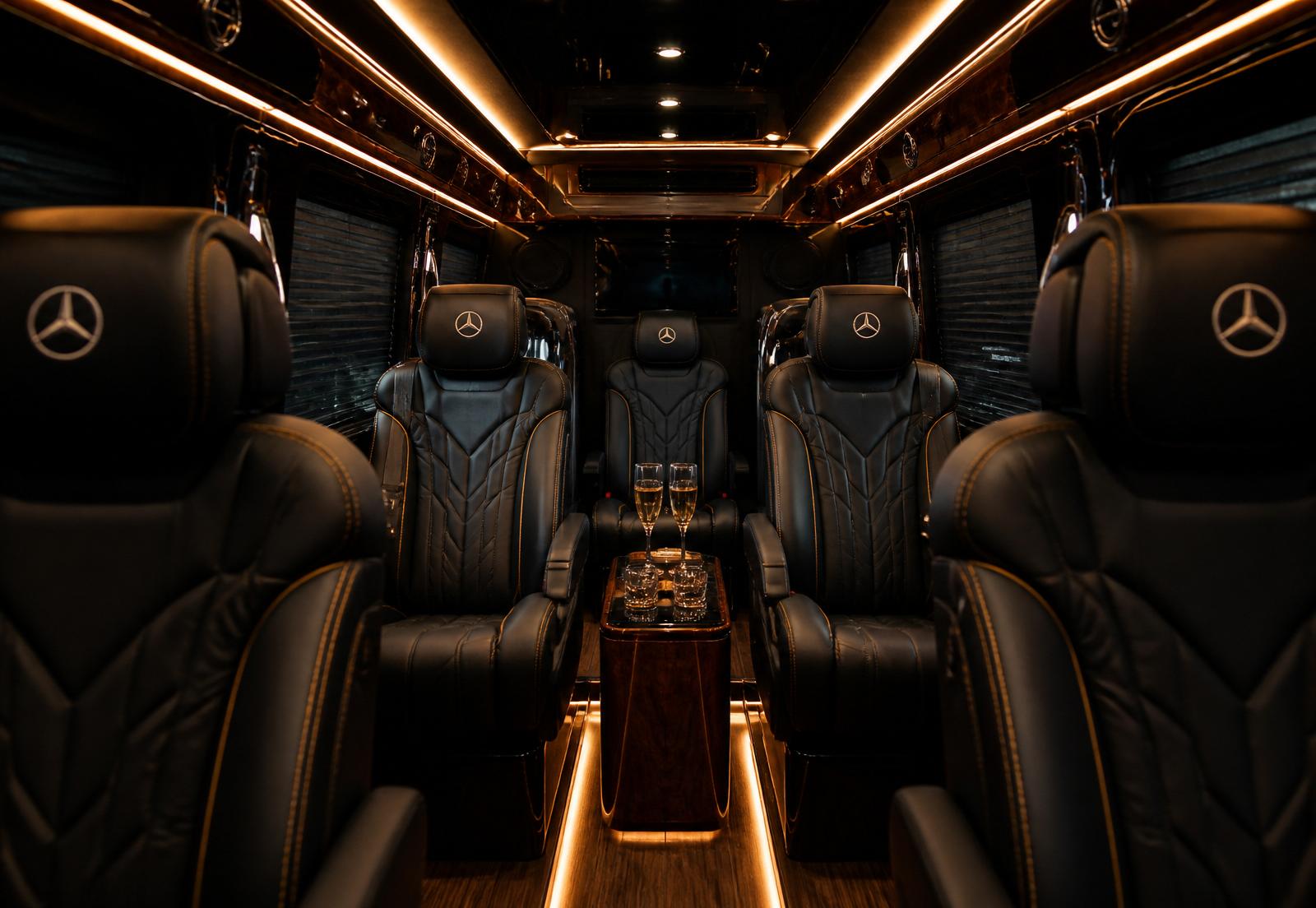 Luxury interior of a Mercedes-Benz Sprinter with gold ambient lighting